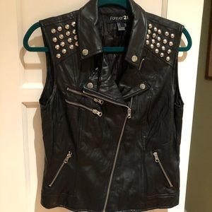Black faux leather sleeveless jacket.